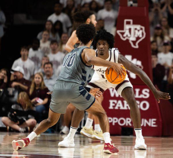 <p>Sophomore F Solomon Washington (13) guards Oral Roberts G Issac McBride (10) during Texas A&M's game against Oral Roberts in Reed Arena on Friday, Nov. 17, 2023.</p>