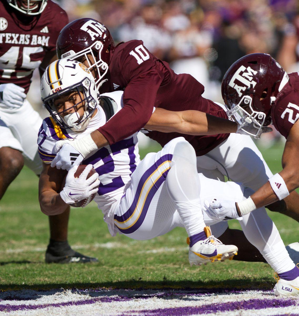 <p>Junior DL Fadil Diggs (10) tackles LSU RB Josh Williams (27) during Texas A&M's game against LSU on Saturday, Nov. 25, 2023 at Tiger Stadium (Katelynn Ivy/The Battalion)</p>