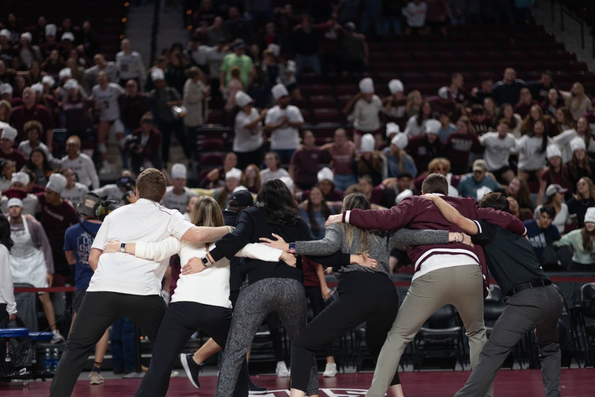 The coaches sway to the war hymn after Texas A&Ms game against Alabama on Friday, Nov. 3, 2023 at Reed Arena.