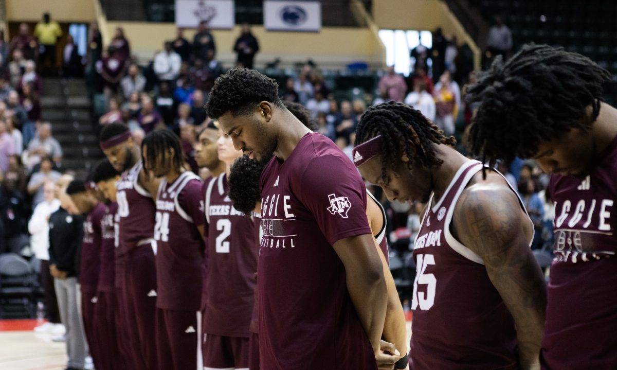 Senior F Henry Coleman III bows his head during the national anthem before Texas A&amp;M's game against FAU at the ESPN Events Invitational in Kissimmee, Florida on Friday, Nov. 24, 2023.