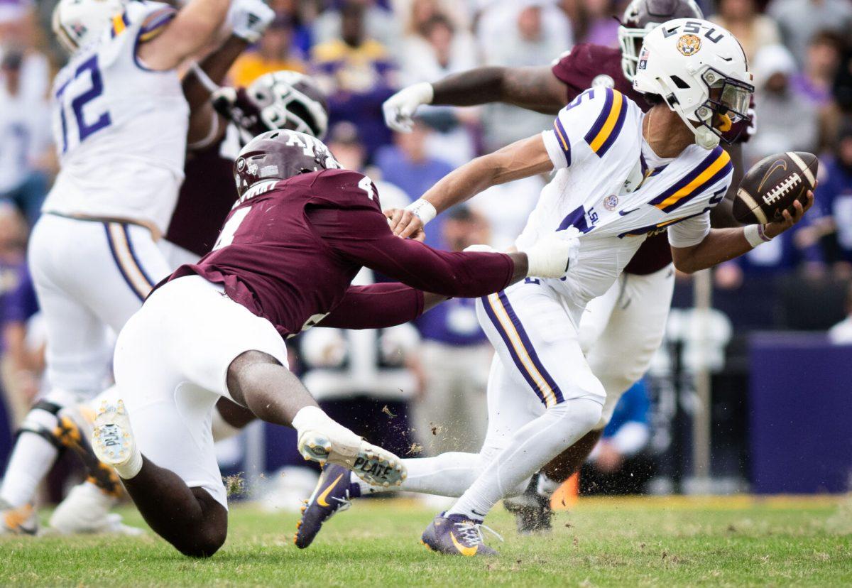 Sophomore DL Shemar Stewart (4) grabs LSU QB Jayden Daniels (5) by the jersey during Texas A&amp;M's game against LSU on Saturday, Nov. 25, 2023 at Tiger Stadium (Katelynn Ivy/The Battalion)