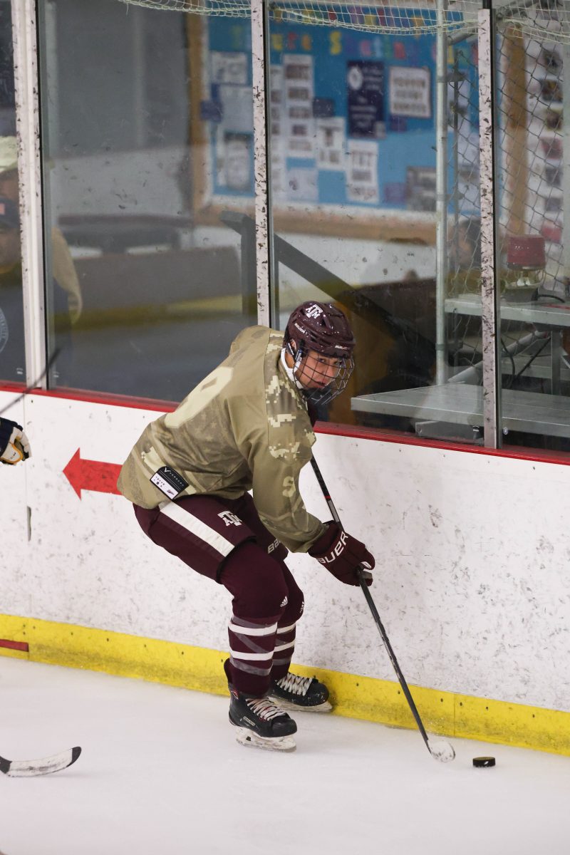 Sophomore Defensemen Cale Morrow (9) gains control of the puck against the glass during Texas A&amp;M's game against ETBU on Saturday, Nov. 4, 2023 at Spirit Ice Arena.