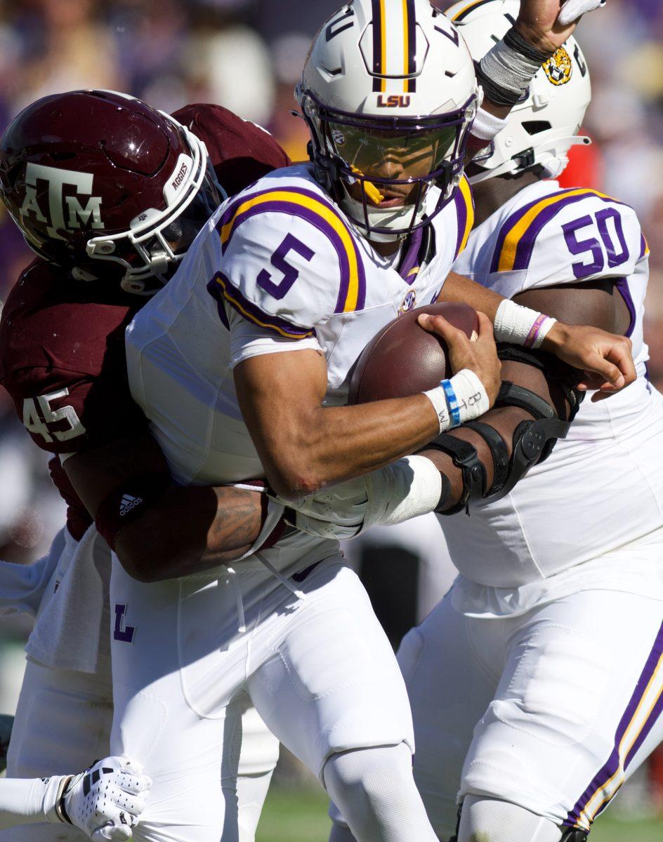 Junior LB Edgerrin Cooper (45) tackles LSU QB Jayden Daniels (5) during Texas A&Ms game against LSU on Saturday, Nov. 25, 2023 at Tiger Stadium (Katelynn Ivy/The Battalion)