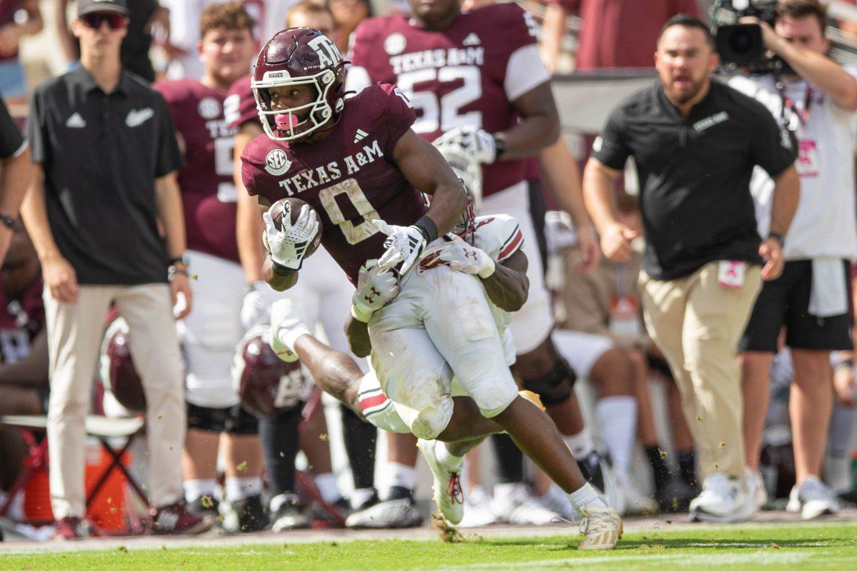 Graduate WR Ainias Smith (0) runs as he is being tackled during Texas A&Ms game vs. South Carolina at Kyle Field on Saturday, Oct. 28, 2023.