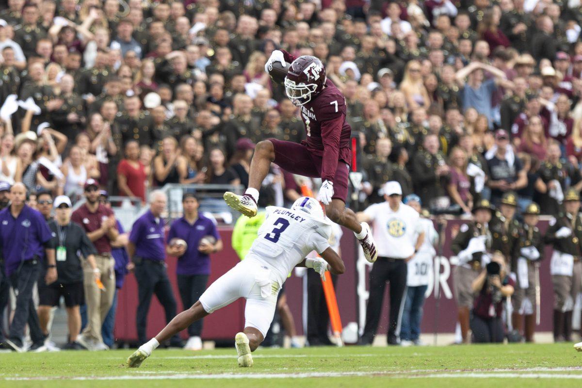 Junior WR Moose Muhammad III hurdles over sophomore S Dorian Plumley (3) in Texas A&amp;M's game against ACU on Satuurday Nov. 18 2023 at Kyle Field. (Julianne Shivers/ The Battalion)