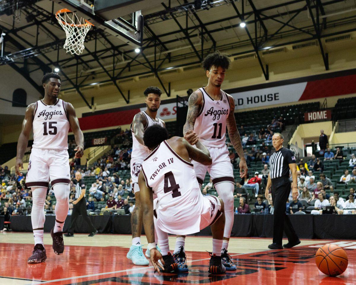 Senior F Andersson Garcia and junior G Jace Carter (0) help up junior G Wade Taylor IV (4) during Texas A&M's game against Penn State at the ESPN Events Invitational in Kissimmee, Florida on Thursday, Nov. 23, 2023.