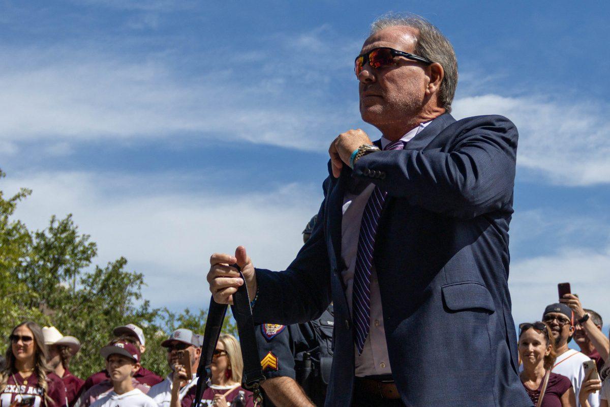 Texas A&M Head Coach Jimbo Fisher adjusts his suit before Texas A&Ms game against Alabama on Saturday, Oct. 7, 2023. (Chris Swann/The Battalion)