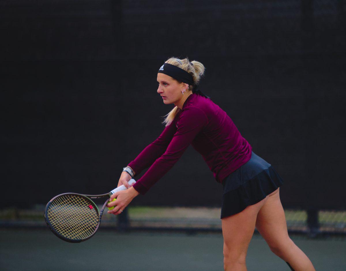 <p>Freshman Daria Smetannikov getting ready to serve at Mitchell Outdoor Tennis Center on Friday, Jan. 20, 2023.</p>