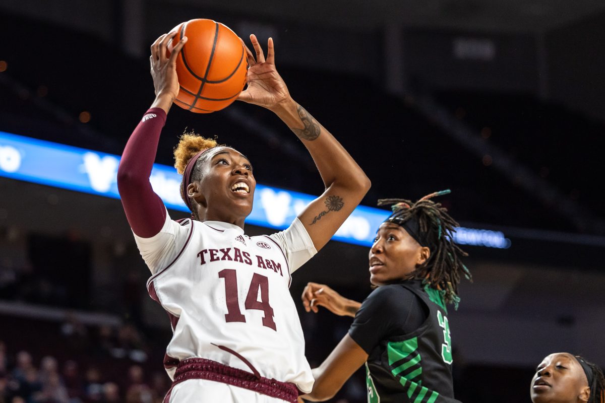 Junior F MJ Johnson (14) Jumps to make a shot against a North Texas defender during Texas A&Ms game against North Texas at Reed Arena on Sunday, Nov. 12, 2023. (Chris Swann/The Battalion)