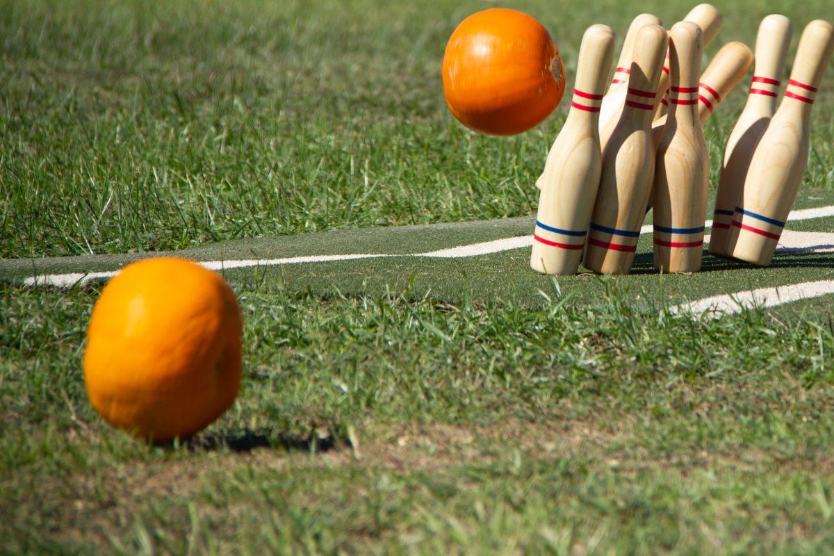 Pumpkin knocks pins in Pumpkin Bowling competition during Pumpkinpalooza at the Millican Reserve on Oct 15, 2023(Adriano Espinosa/ The Battalion).