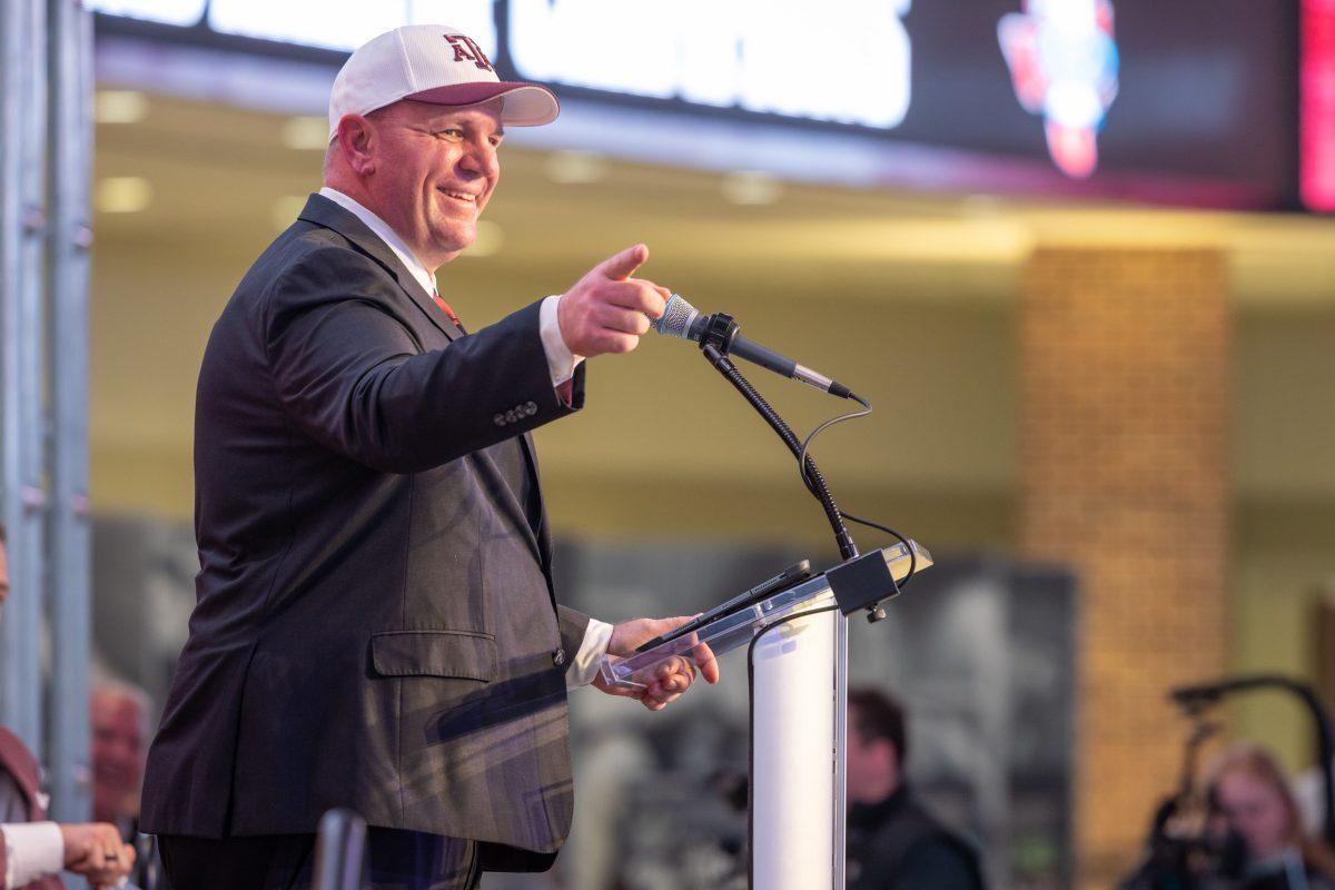 Texas A&amp;M Head Coach Mike Elko points to the band while speaking to media, fans and faculty in Kyle Field on Monday, Nov. 27, 2023. (Chris Swann/The Battalion)