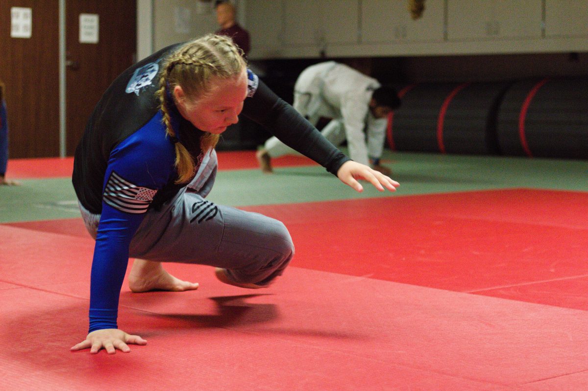 <p>Class at the A&M Brazilian Jiu Jitsu class begins with warmups. Students like Riley Wilson, a sophomore engineering major and blue belt in Brazilian Jiu Jitsu, practice basic movements used in grappling to build dexterity and muscle memory. (Nov 24, 2023)</p>