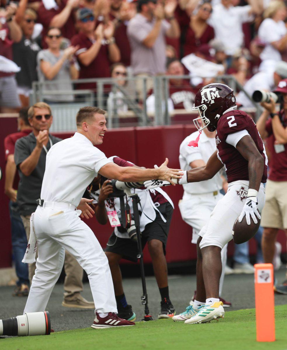 <p>Head Yell Leader Ethan Davis high fives Freshman RB Rueben Owens (2) after he scores a touchdown during Texas A&M's game vs. South Carolina at Kyle Field on Satuday, Oct. 28, 2023.</p>