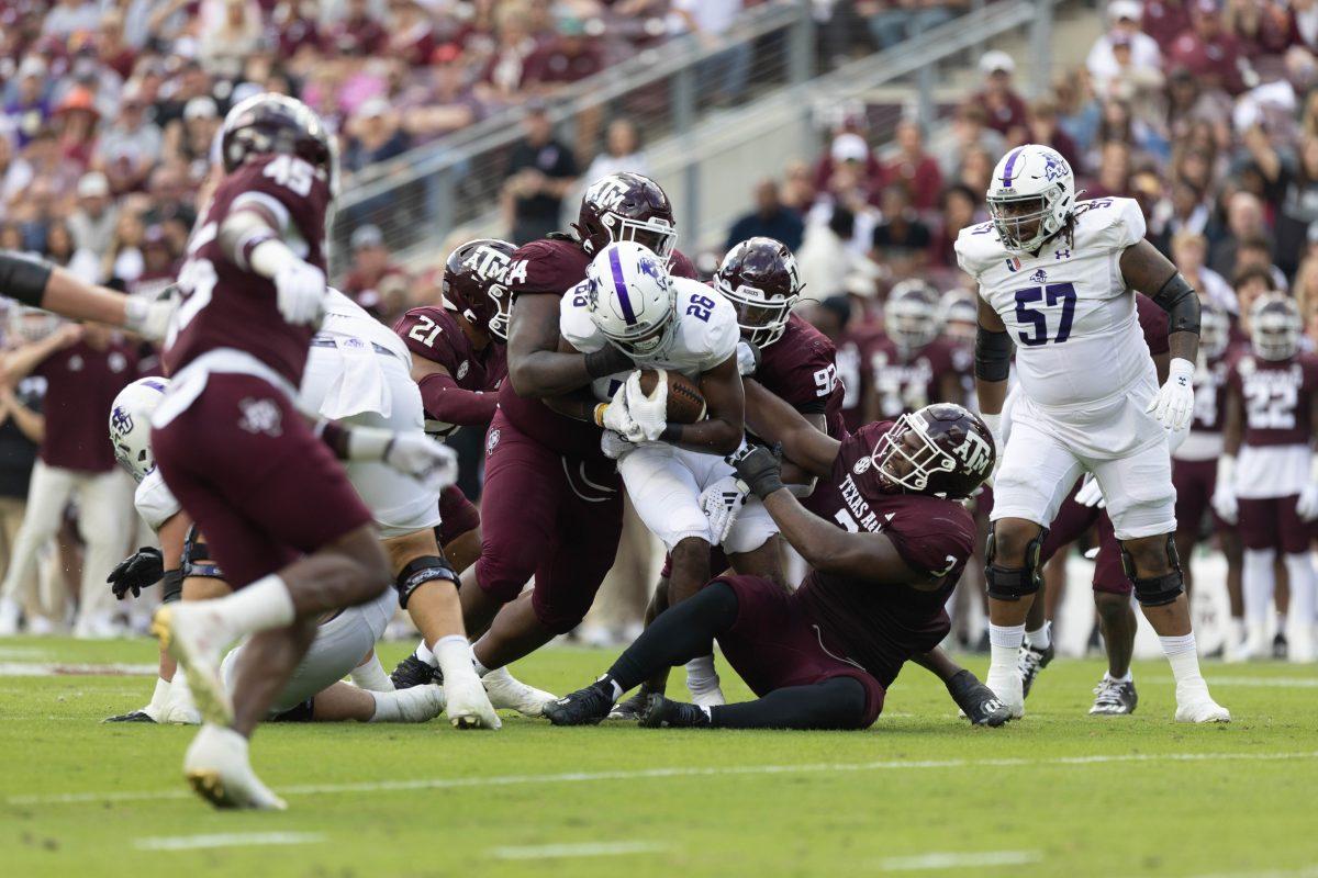 Texas A&Ms defense takes down a ACU RB at Texas A&Ms game against ACU on Saturday, Nov. 18, 2023 at Kyle Field. (Julianne Shivers/ The Battalion)