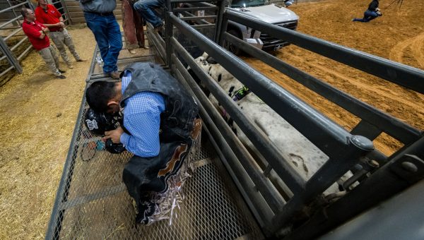 Bull rider Cesar Carrillo prays before riding at the second round of the bull riding competition on Saturday, Oct. 21, 2023. (Ishika Samant/The Battalion)