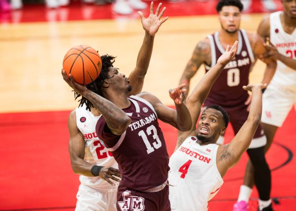 Sophomore F Solomon Washington (13) passes the ball to his teammates during Texas A&M's game against Houston on Saturday, Dec. 16, 2023 at the Toyota Center in Houston, Texas.