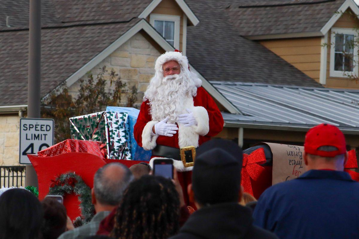 <p>Sanata Clause waving and spreading christmas joy to the crowd at the College Station Christmas Parade Dec. 2, 2023</p>