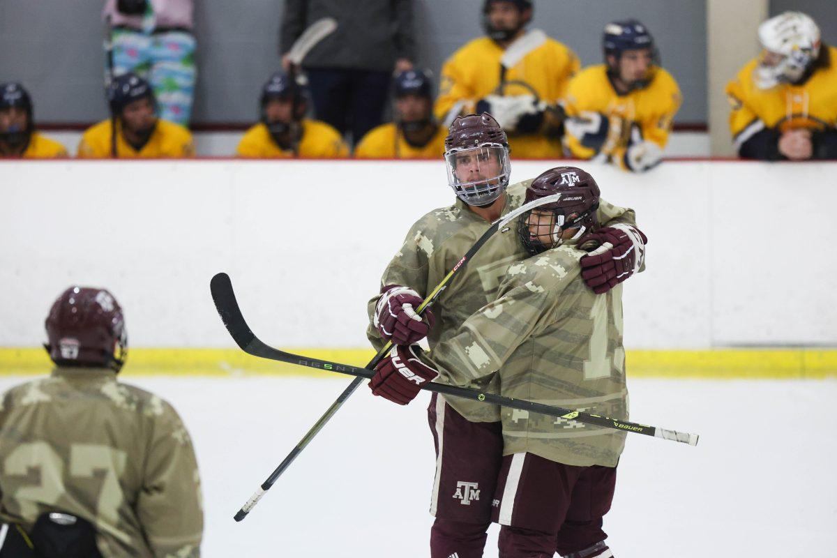 Graduate Defensemen Jacob Norwood (62) pats Senior Forward Matthew Perri (15) on the back after he scores a goal during Texas A&Ms game against ETBU on Saturday, Nov. 4, 2023 at Spirit Ice Arena.