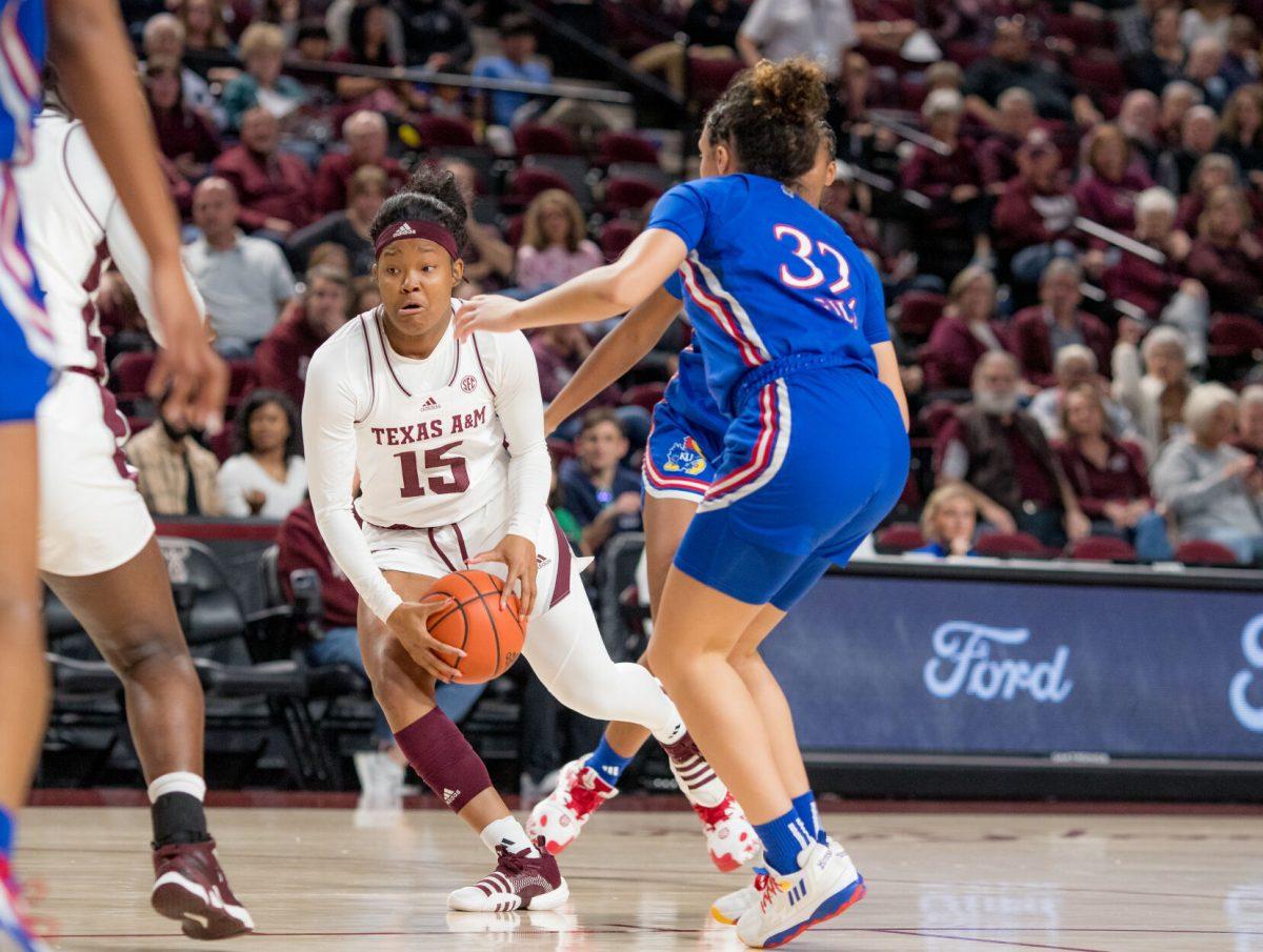 Freshman G Sole Green (15) dribbles the ball during Texas A&Ms game against Kansas on Sunday, Dec. 3, 2023 at Reed Arena. (Ishika Samant/The Battalion)