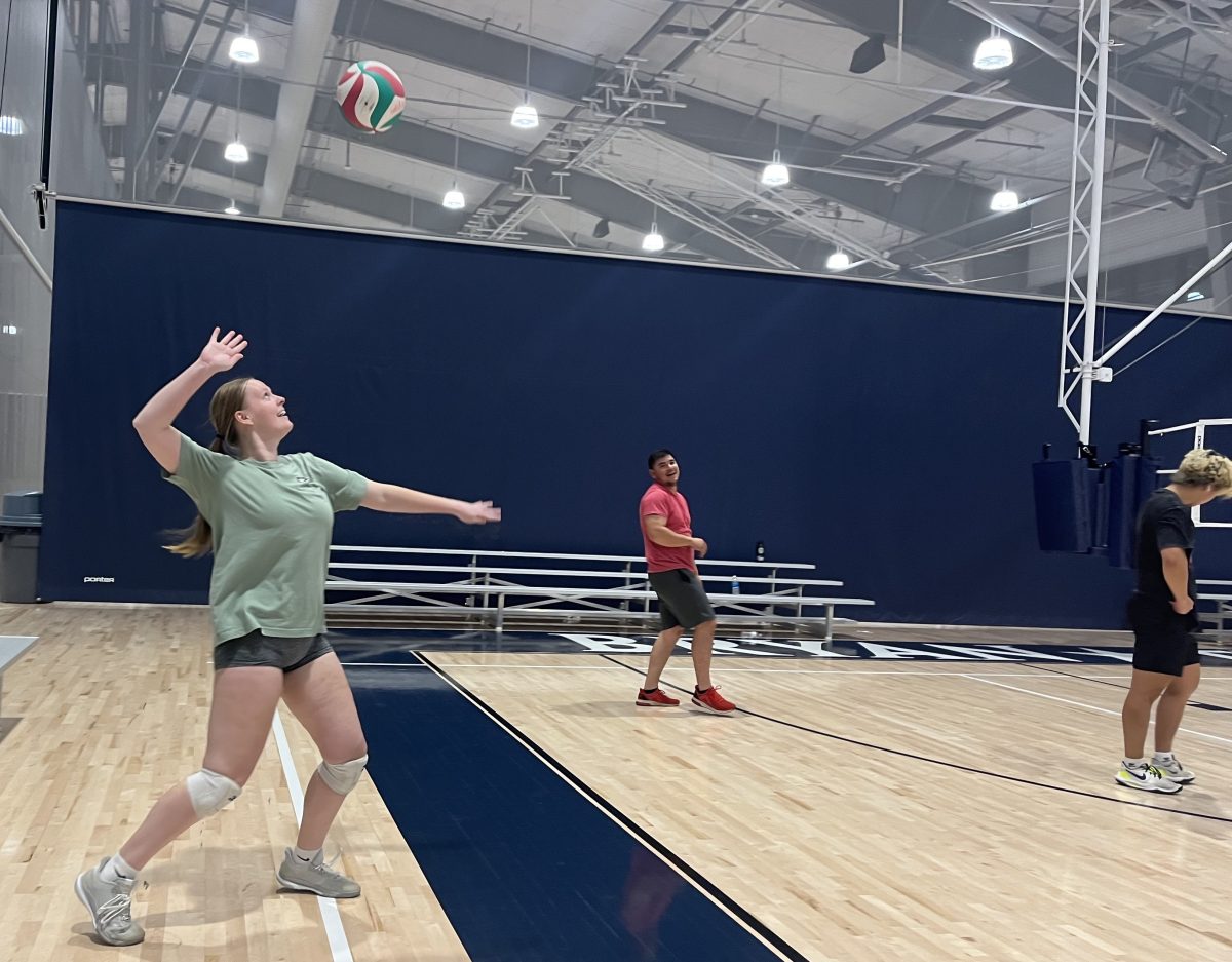 Forensic and investigative sciences senior Emily Linhart serves during open gym on Nov. 14 at the Legends Event Center in Bryan. 