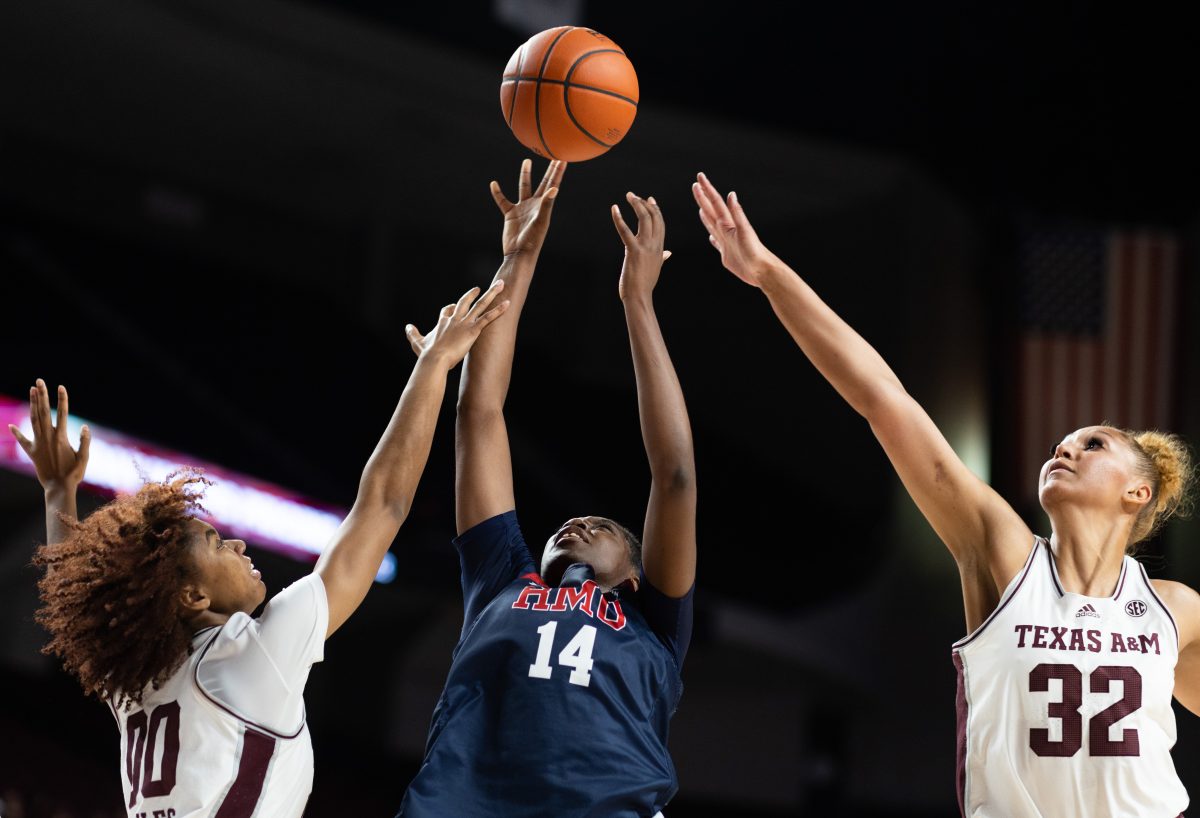 <p>Junior F Lauren Ware (32) and Sophomore G Sydney Bowles (0) jump for a block during Texas A&M's game against Robert Morris on Saturday, Dec. 9th.</p>
