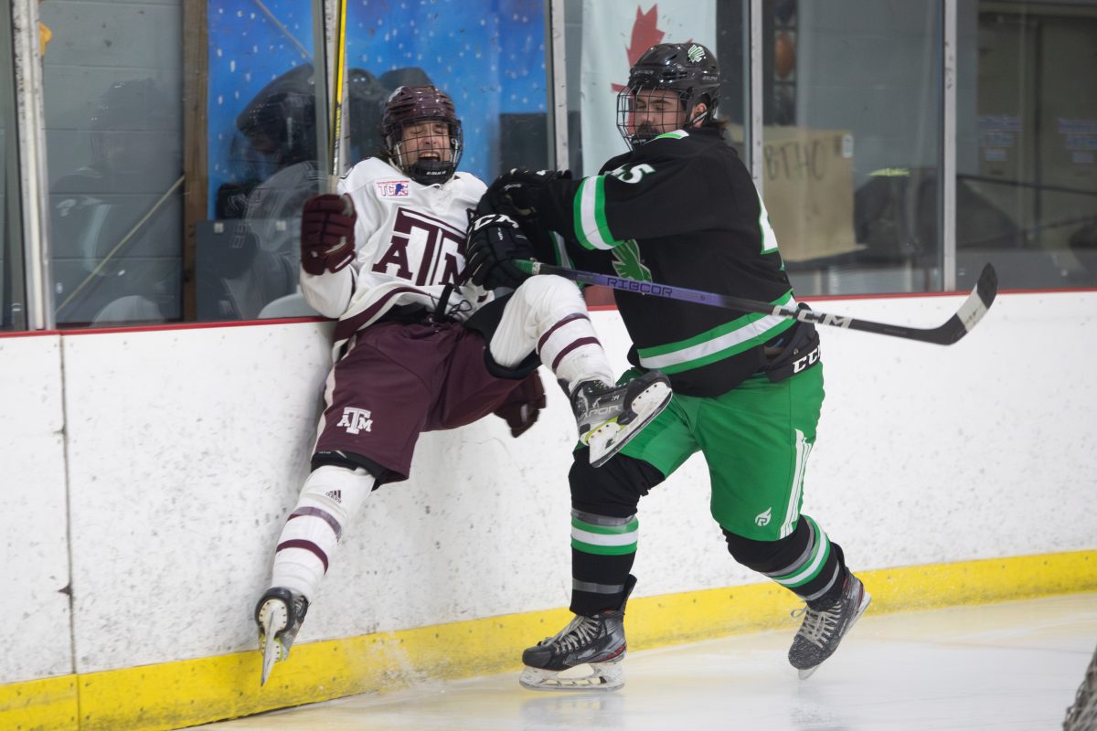 Junior F Robby Sours (43) gets charged in Texas A&Ms second game against UNT on Saturday, Dec. 2nd, 2023 at Spirit Ice Arena. (Julianne Shivers/ The Battalion)