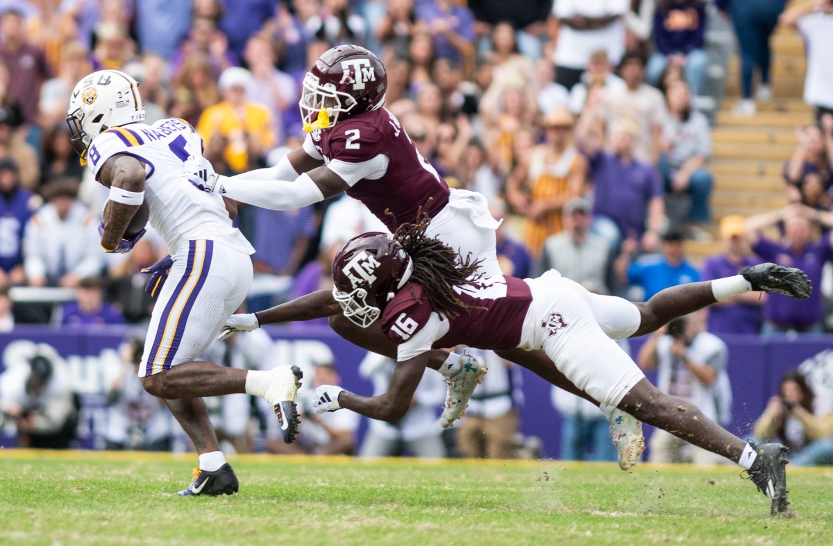 Sophomore DB Jacoby Mattews (2) and sophomore DB Sam McCall (16) attempt to stop LSU WR Malik Nabers during Texas A&Ms game against LSU on Saturday, Nov. 25, 2023 at Tiger Stadium (Katelynn Ivy/The Battalion)