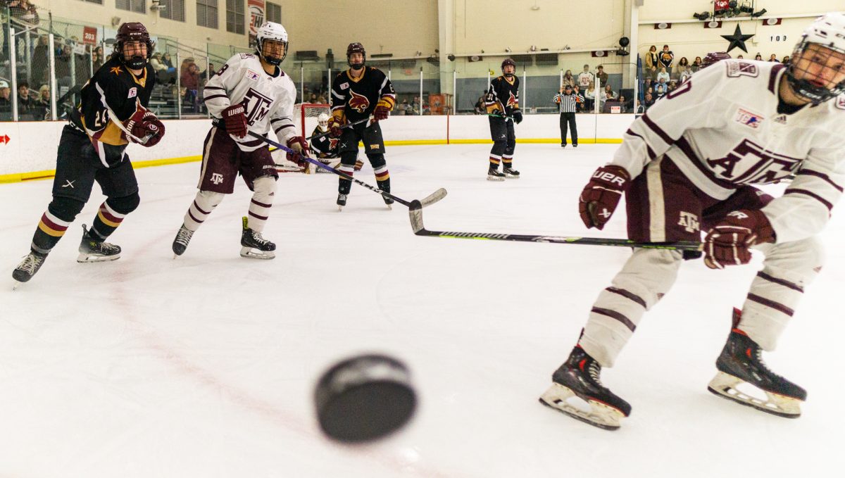 Players scramble to recover a hoisted puck during A&Ms game against Texas State on Saturday, Jan. 20 at Spirit Ice Arena.