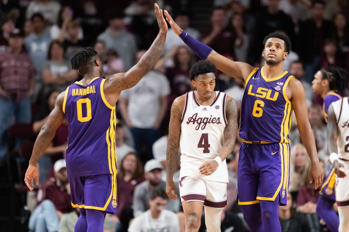 Junior G Wade Taylor (4) walks towards the bench as LSU G Trae Hannibal (0) high-fives G Jordan Wright (6) after drawing a foul during Texas A&M’s game against LSU on Saturday, Jan. 6, 2024 at Reed Arena (Chris Swann/The Battalion)