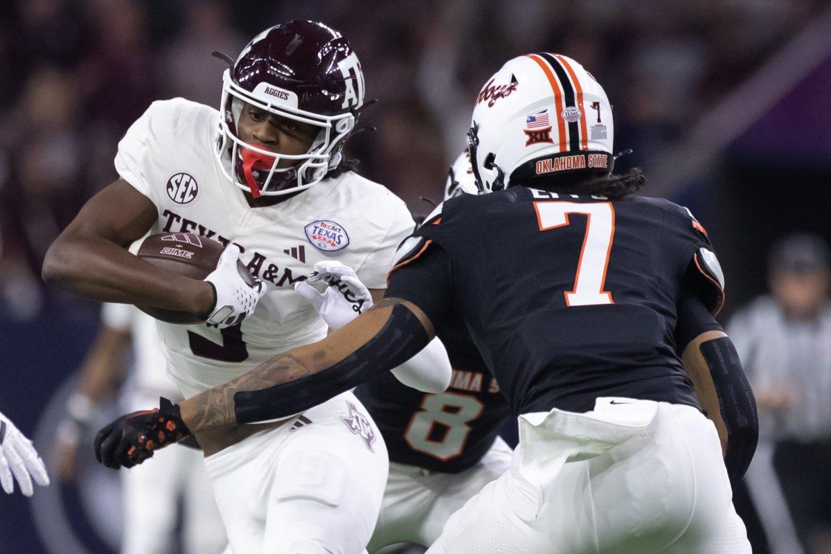 Junior WR Jahdae Walker (9) jukes away from OSU S Cameron Epps (7) for a first down during the 2023 TexAct Texas Bowl on Wednesday, Dec. 27, 2023 at NRG Stadium. (Chris Swann/The Battalion)