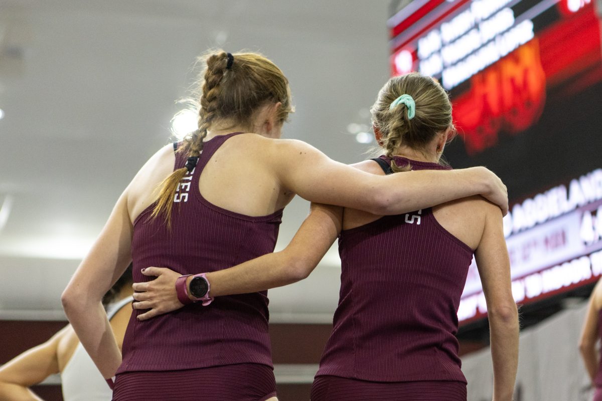 Texas A&M long distance runners hug during the Ted Nelson Invitional at the Murray Fasken Indoor Track on Jan. 20, 2024. (Mattie Taylor/The Battalion)