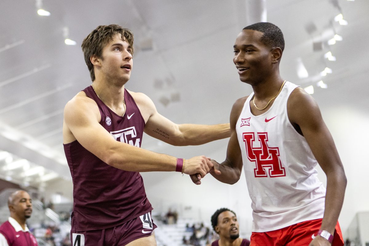 Texas A&M senior Connor Schulman celebrates with Houstons athlete during the Ted Nelson Invitional at the Murray Fasken Indoor Track on Jan. 20, 2024. (Mattie Taylor/The Battalion)