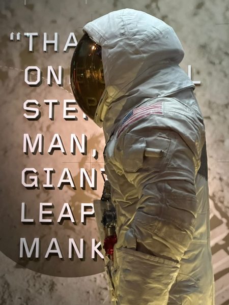 An astronaut suit stands in front of Neil Armstrongs famous quote at an exhibit in the Smithsonianss National Air and Space Museum on Jan. 12, 2024. (Nicholas Gutteridge/The Battalion)