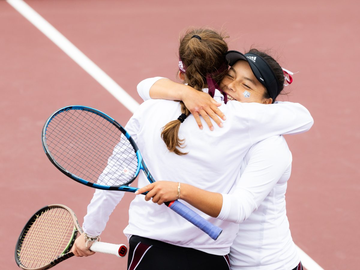 Freshman Lucciana Perez embraces sophomore Nicole Khirin after Texas A&Ms doubles victory against Northwestern at Mitchell Outdoor Tennis Center on Saturday, Jan. 27, 2024. (Kyle Heise/The Battalion)