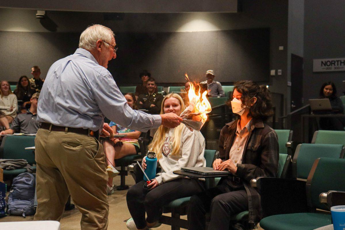Dr. David Reed, professor of horticulture, conducts an experiment in front of business administration freshman Vivian Thornton during his lecture at the ILCB on Thursday, Feb. 15, 2024. (Photo by Ashely Bautista/The Battalion)
