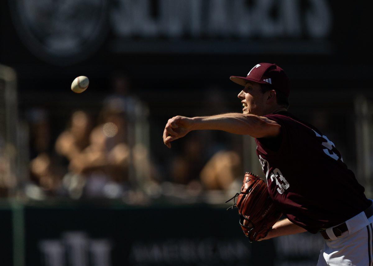 Texas A&M pitcher Justin Lamkin (33) throws the ball during Texas A&M’s game against Wagner on Saturday, Feb. 24, 2024, at Blue Bell Park. (Ishika Samant/The Battalion)