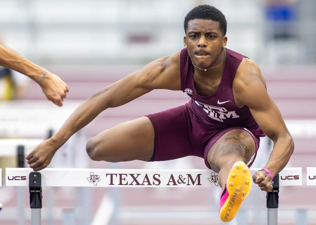Texas A&M freshman Arveyon Davis clears the hurdle during the Charlie Thomas Invitational at the Murray Fasken Indoor Track on Friday, Feb. 2, 2024. (CJ Smith/The Battalion)