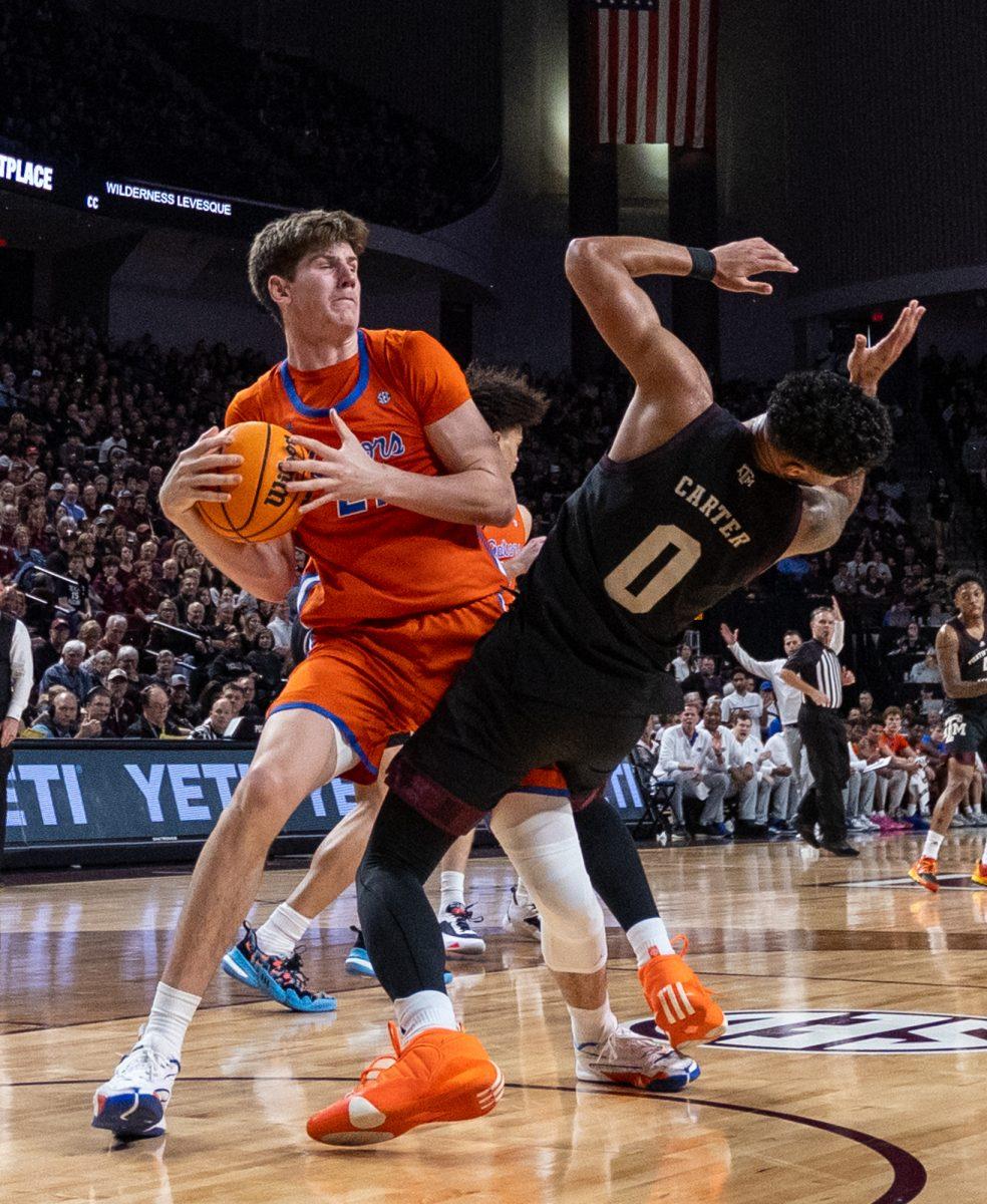 Junior G Jace Carter is pushed off by Florida Freshman F Alex Condon (21) during Texas A&Ms game against Florida on Saturday, Feb. 3, 2024 at Reed Arena