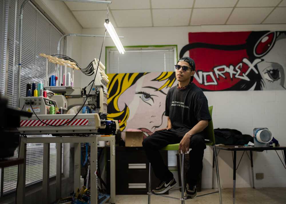 Owner of Vortex, Victor Lucio, sits for a portrait in the corner of his store on 2609 S. College Avenue. (Ishika Samant/The Battalion)