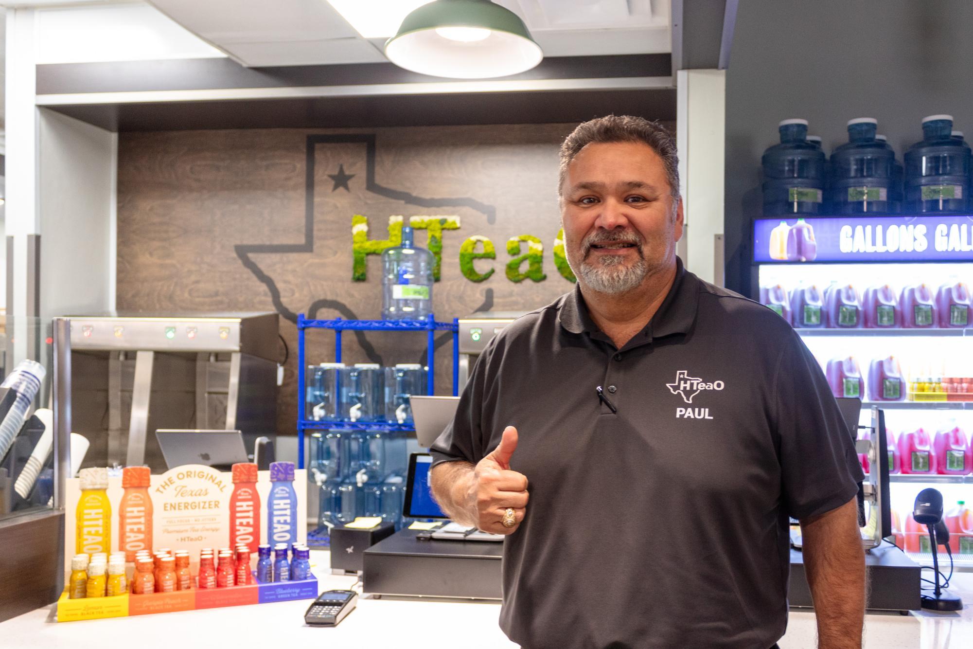 HTeaOs College Station store operator, Paul Torres, Class of 2002, stands for a photo on Friday, Feb. 2, 2024. 