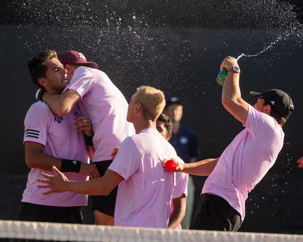 The A&M Mens Tennis team celebrate after Sophomore Togan Tokacs winning set at Texas A&Ms match against Pepperdine on Sunday, Feb. 25, 2024, at the Mitchell Tennis Center. (© Connor May/The Battalion)