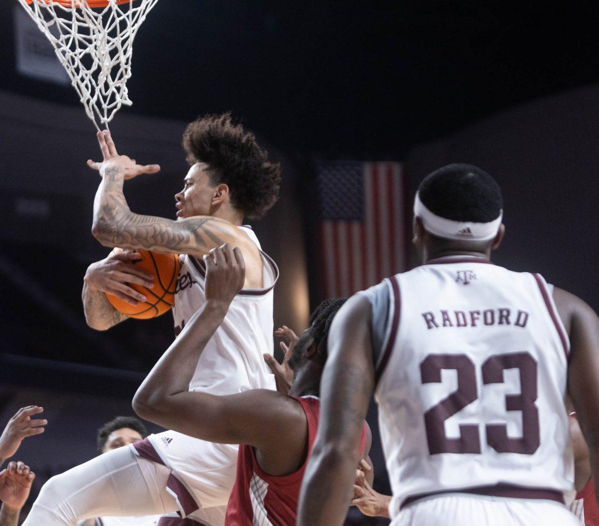 Senior F Andersson Garcia (11) grabs the rebound during Texas A&Ms game against Arkansas on Feb. 20, 2024 at Reed Arena. (Jaime Rowe/The Battalion)