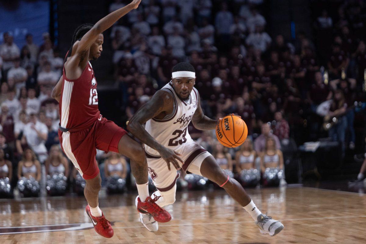 Graduate G Tyrece Radford (23) dribbles around opponent during Texas A&Ms game against Arkansas on Feb. 20, 2024 at Reed Arena. (Jaime Rowe/The Battalion)