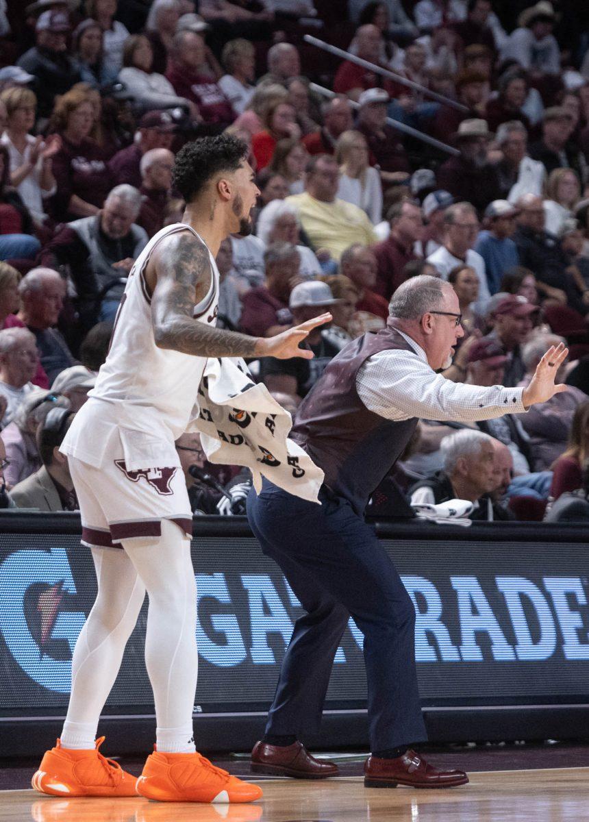 Junior G Jace Carter (0) and Head Coach Buzz Williams talk to the players from the sideline during Texas A&Ms game against Arkansas on Feb. 20, 2024 at Reed Arena. (Jaime Rowe/The Battalion)