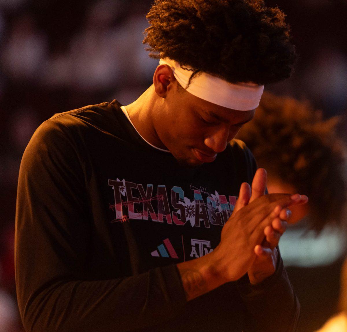 Graduate G Eli Lawrence (5) claps during Texas A&Ms game against Arkansas on Feb. 20, 2024 at Reed Arena. (Jaime Rowe/The Battalion)