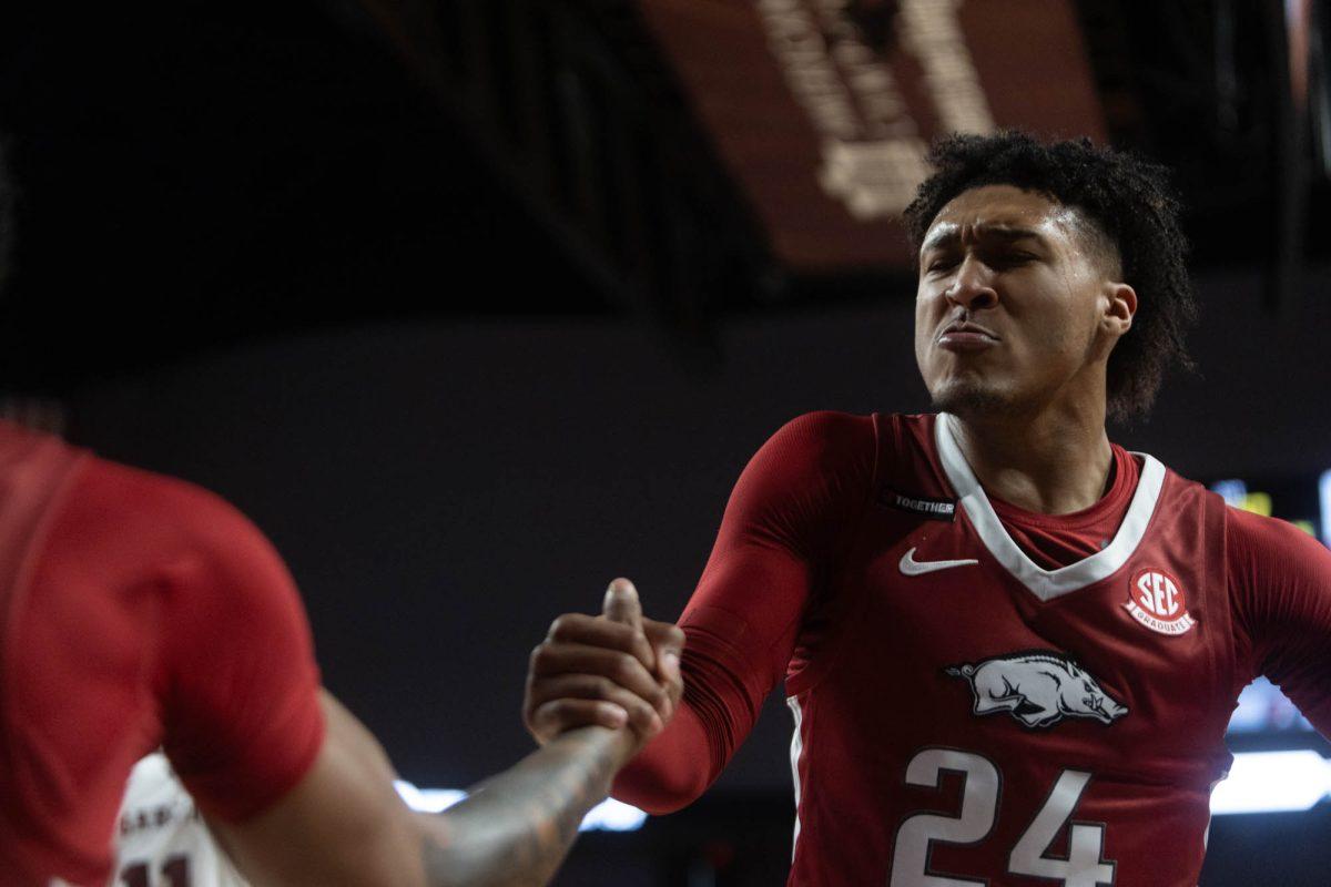 Arkansas Graduate G Jeremiah Davenport (24) helps his teammate up during Texas A&Ms game against Arkansas on Feb. 20, 2024 at Reed Arena. (Jaime Rowe/The Battalion)
