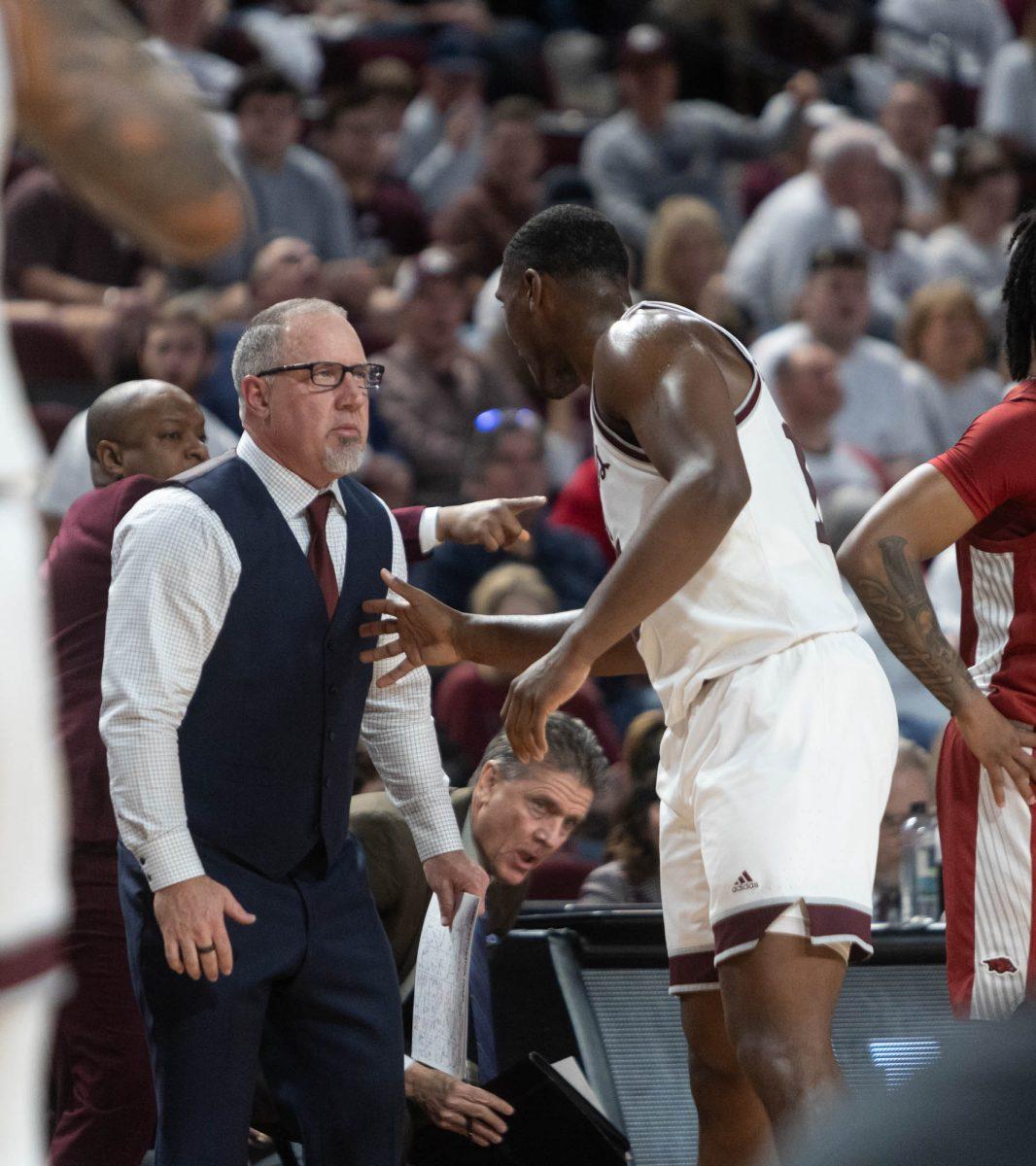 Senior F Henry Coleman (15) talks to head coach Buzz Williams during Texas A&Ms game against Arkansas on Feb. 20, 2024 at Reed Arena. (Jaime Rowe/The Battalion)