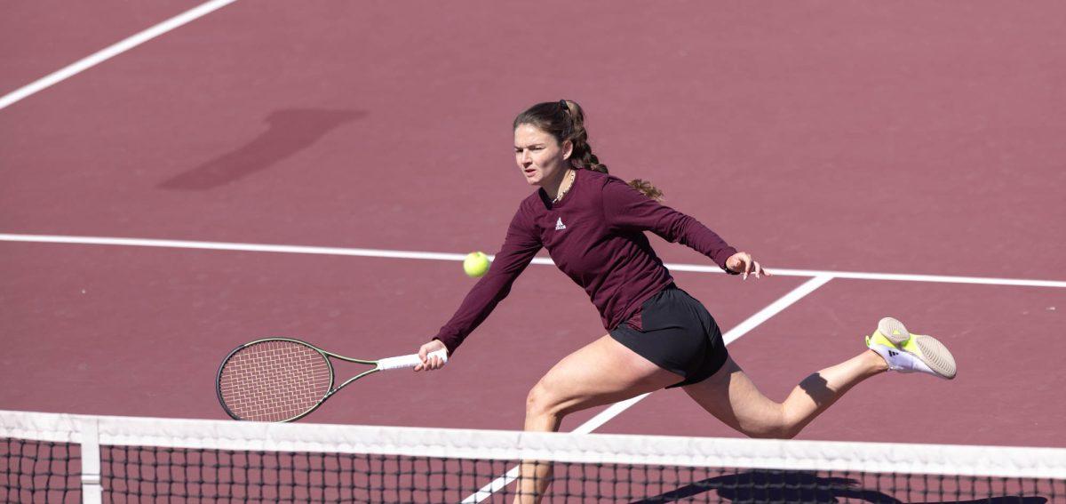 Sophomore Nicole Khirin races along the net to hit the ball during Texas A&Ms match against Rice on Feb. 18, 2024 at the Mitchell Outdoor Tennis Center.