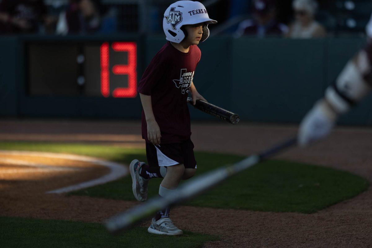 Bat boy goes to pick up the bat during Texas A&Ms game against St. Thomas on Feb. 23, 2024 at Davis Diamond. (Jaime Rowe/The Battalion)