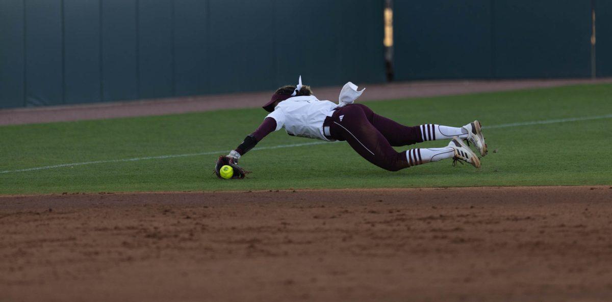 Junior INF Koko Wooley (3) dives for the ball during Texas A&Ms game against St. Thomas on Feb. 23, 2024 at Davis Diamond. (Jaime Rowe/The Battalion)